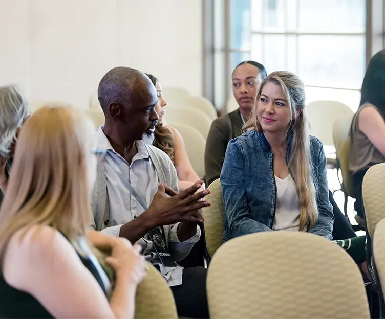 Group of stakeholders engaged in conversation. Stakeholder engagement.