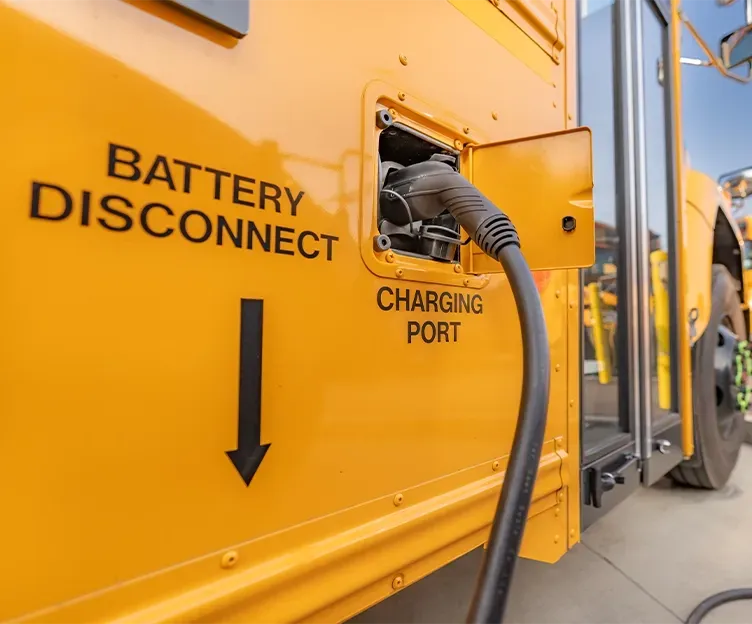 Image of electric school bus charging. Electrification transportation.