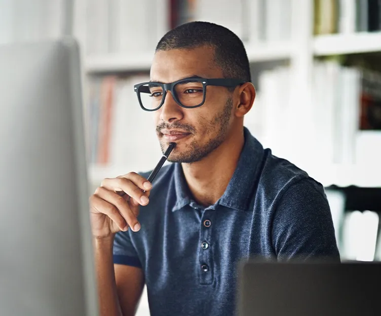 Image of man looking at computer screen inquisitively. Engineering studies,