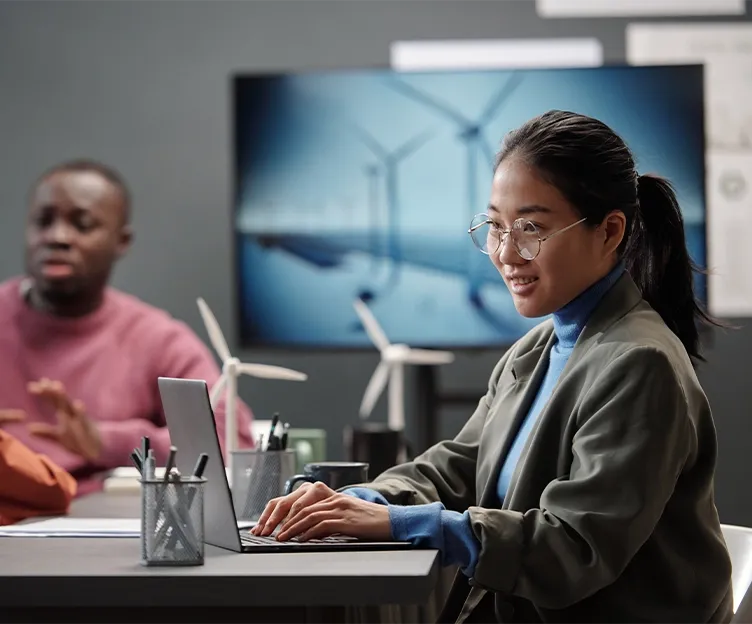Image of two energy professionals working on a wind turbine renewable energy project. Program and project management.