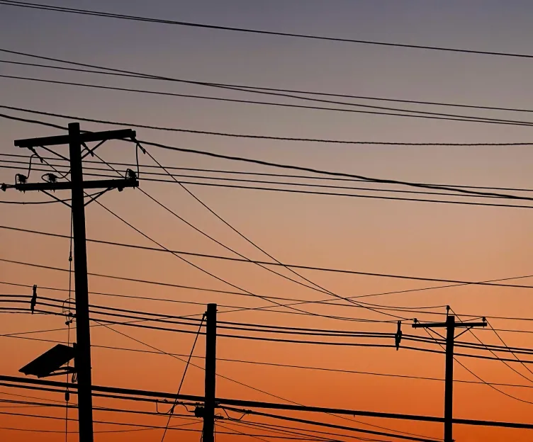 Image of transmission lines at sunset. Planning interconnection operations distribution design