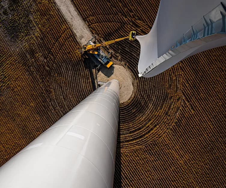 Image of wind turbine installation on field. Policy and regulatory. NERC Compliance. North American Electric Reliability Corporation.